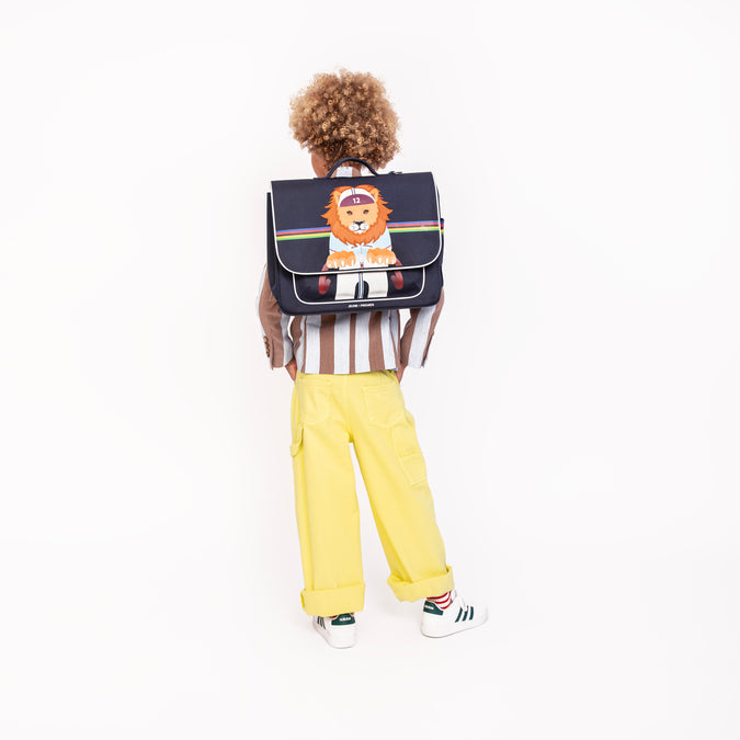 Boy wearing Jeune Premier It Bag Midi King of the Cobbles school bag, age 6 to 8