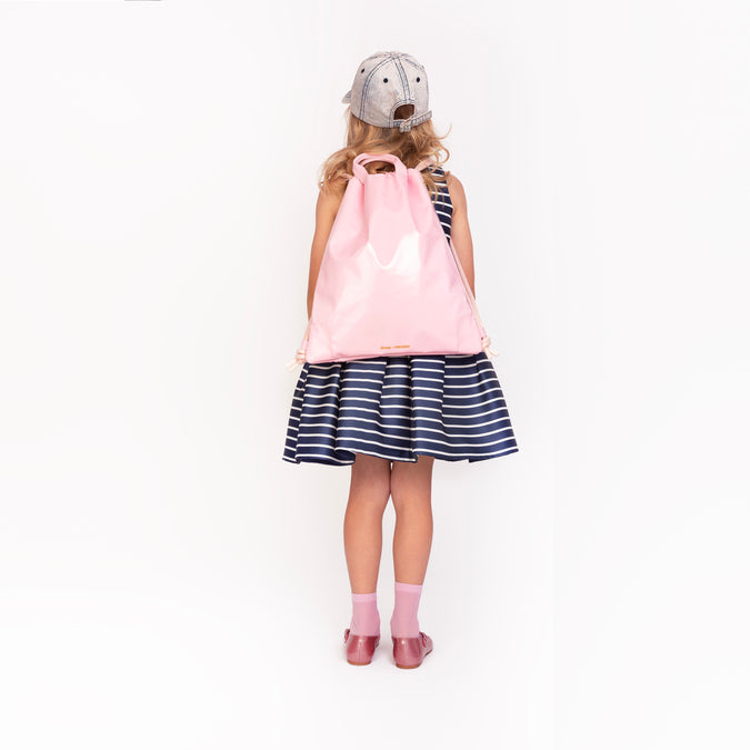 Girl wearing Jeune Premier City Bag Blush as a backpack, convertible straps
